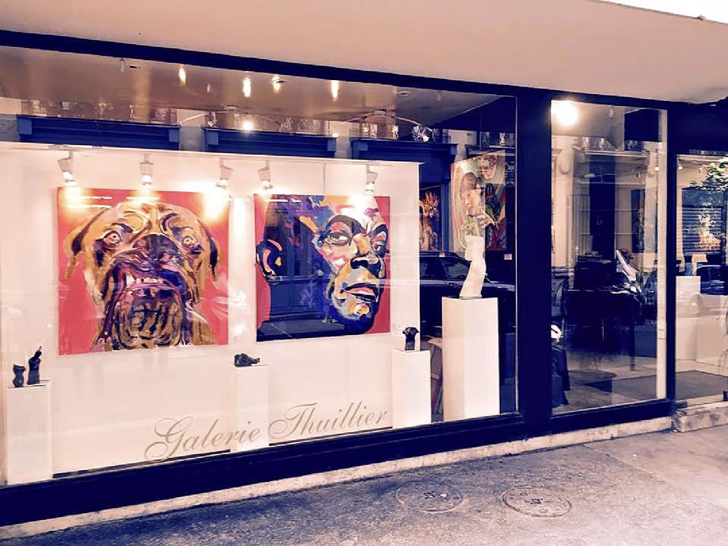 The window of the Galerie Thuillier on rue de Thorigny in Paris, with two large painted portraits on display