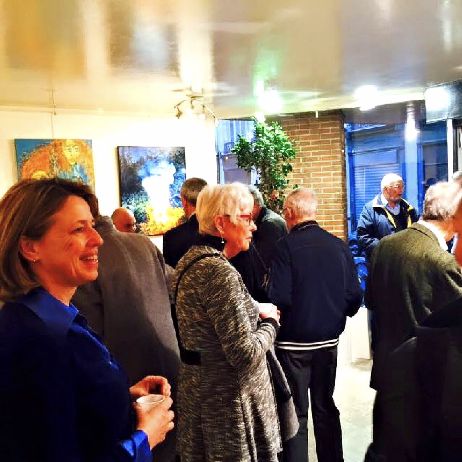 Visitors talking among the works of the group exhibition “Paris 2015” at the Galerie Thuillier