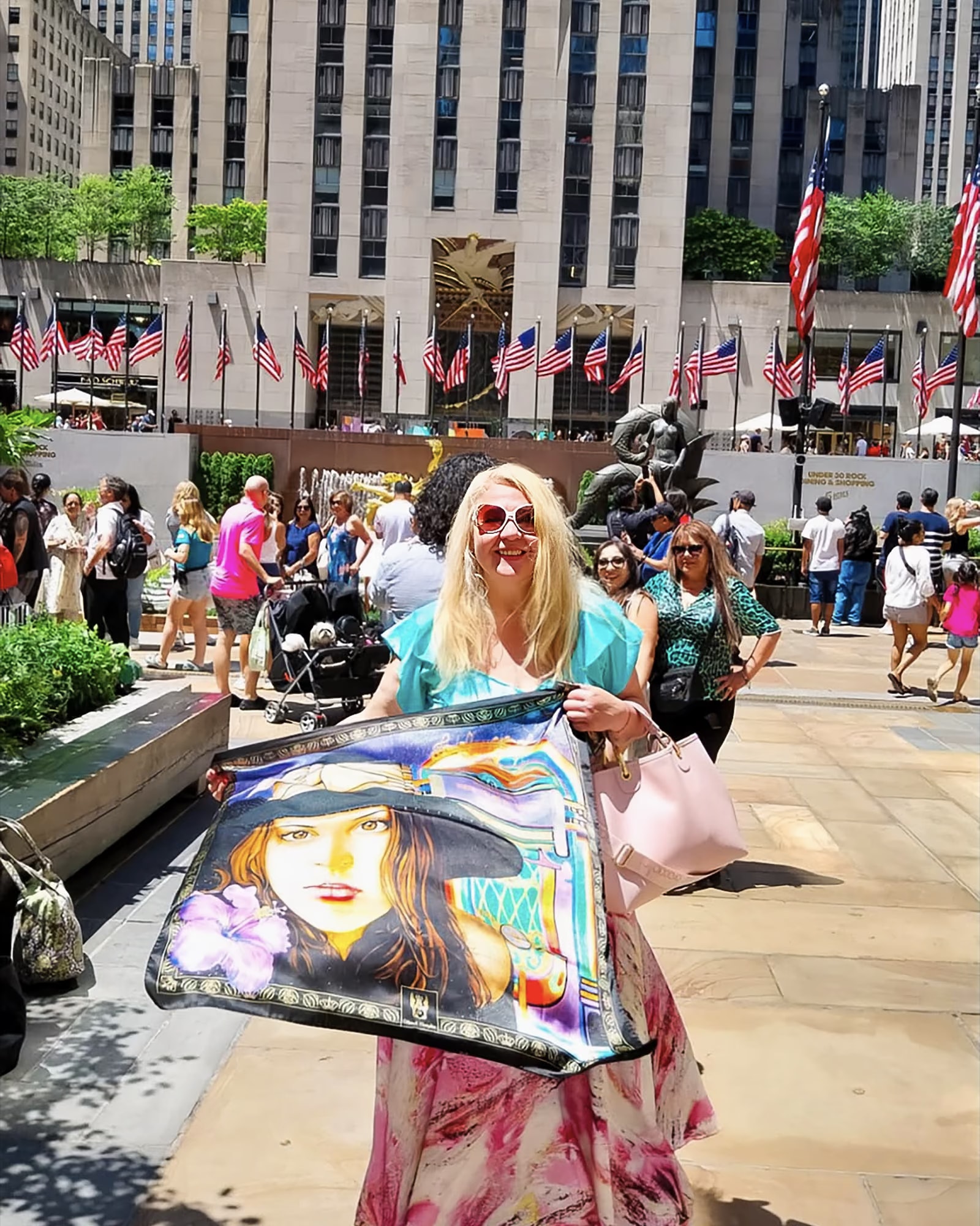 Aida Abdullaeva con il foulard Fanny davanti al Rockefeller Center, fra le bandiere americane